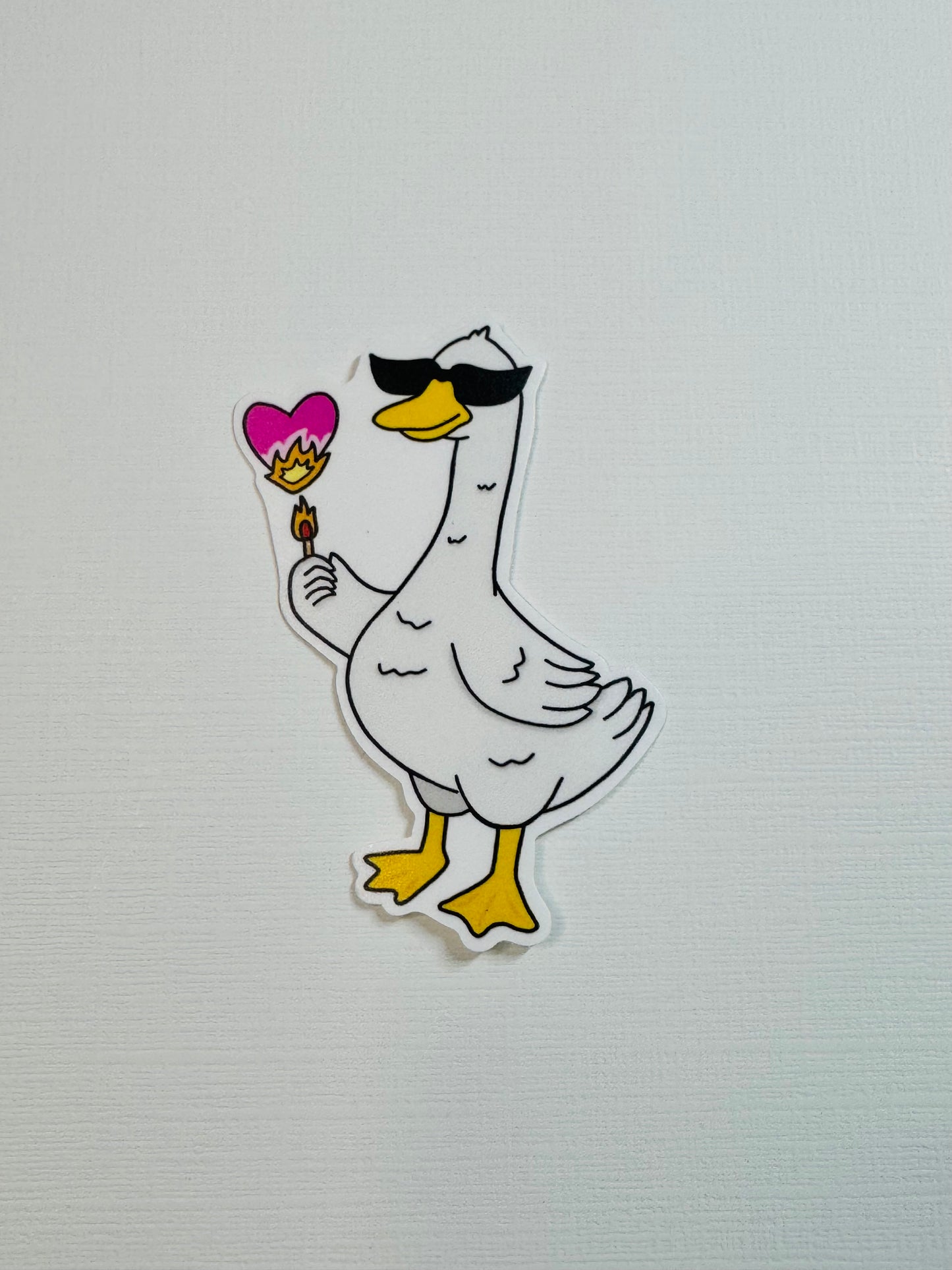Cool Goose Holding a Burning Heart Sticker